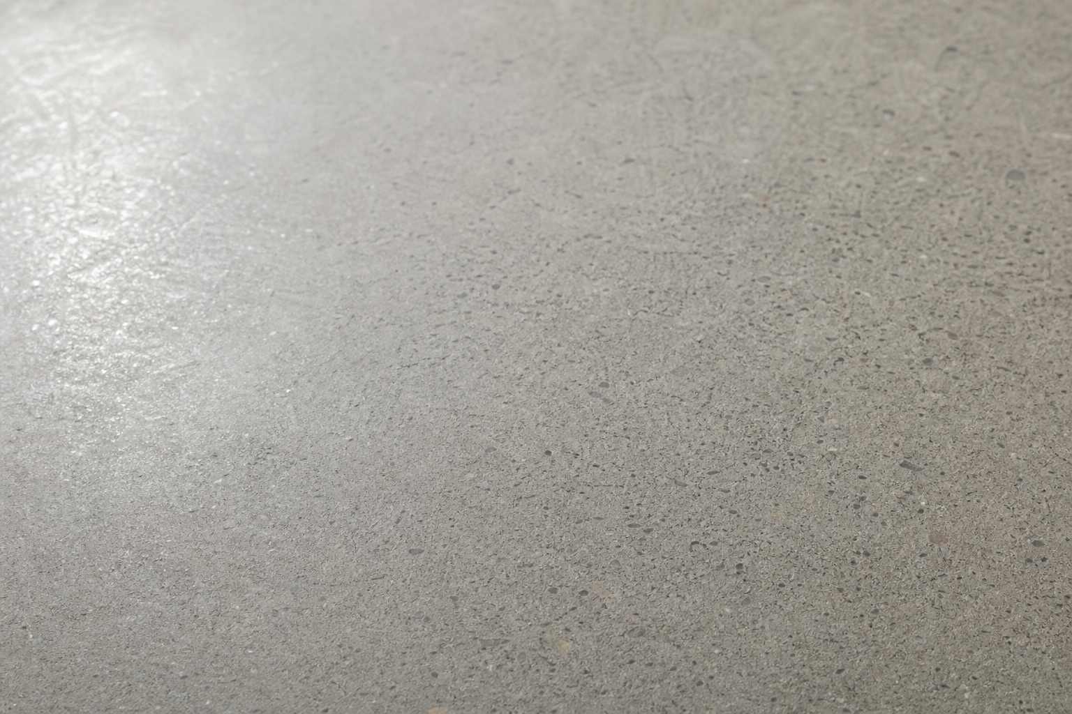 Close-up of honed concrete surface in a Perth alfresco area at 400 grit finish, smooth matte sheen with subtle aggregate visible