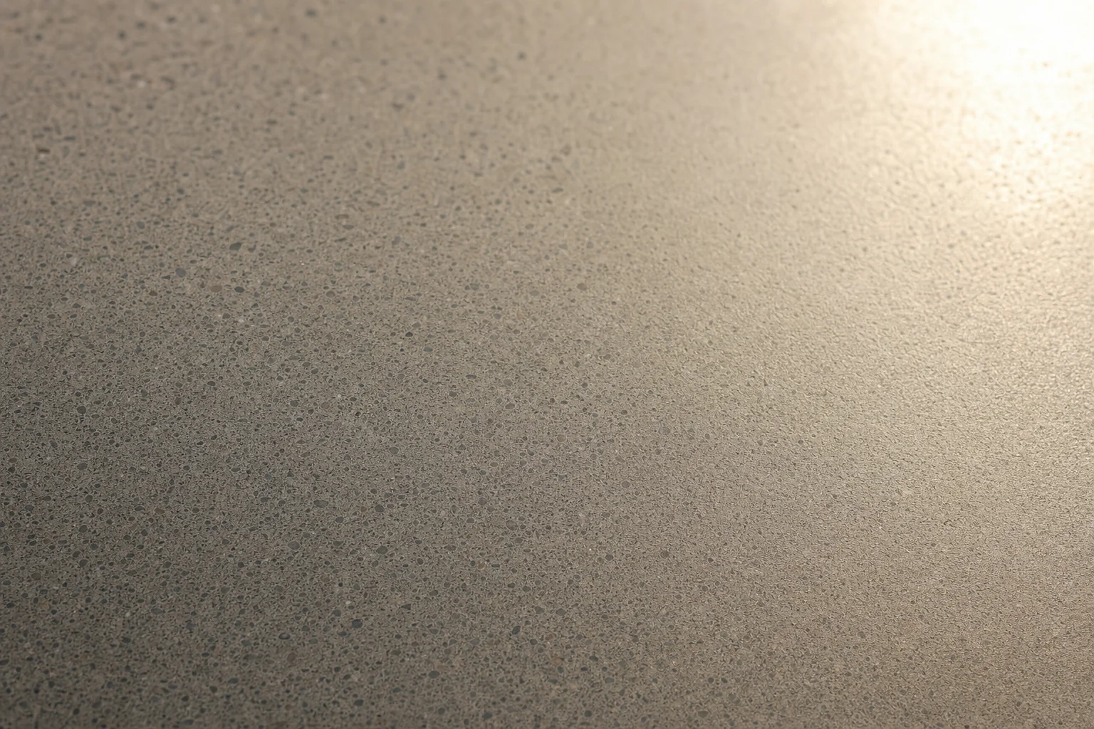 Close-up of a honed concrete surface with a fine smooth matte texture