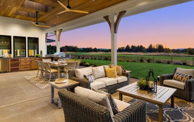 Covered patio with kitchen, dining area, and living area.