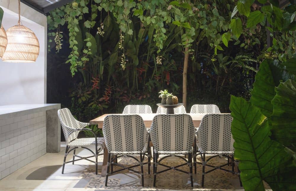 Outdoor dining area surrounded with plants.